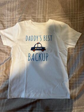 Kids Tee with Blue Police Car & blue text “Daddy’s Best Backup”